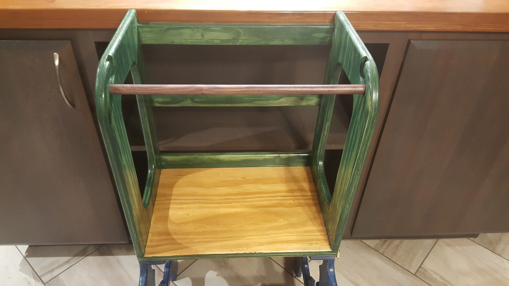 a purple safety bar shown on the top part of a child's step stool